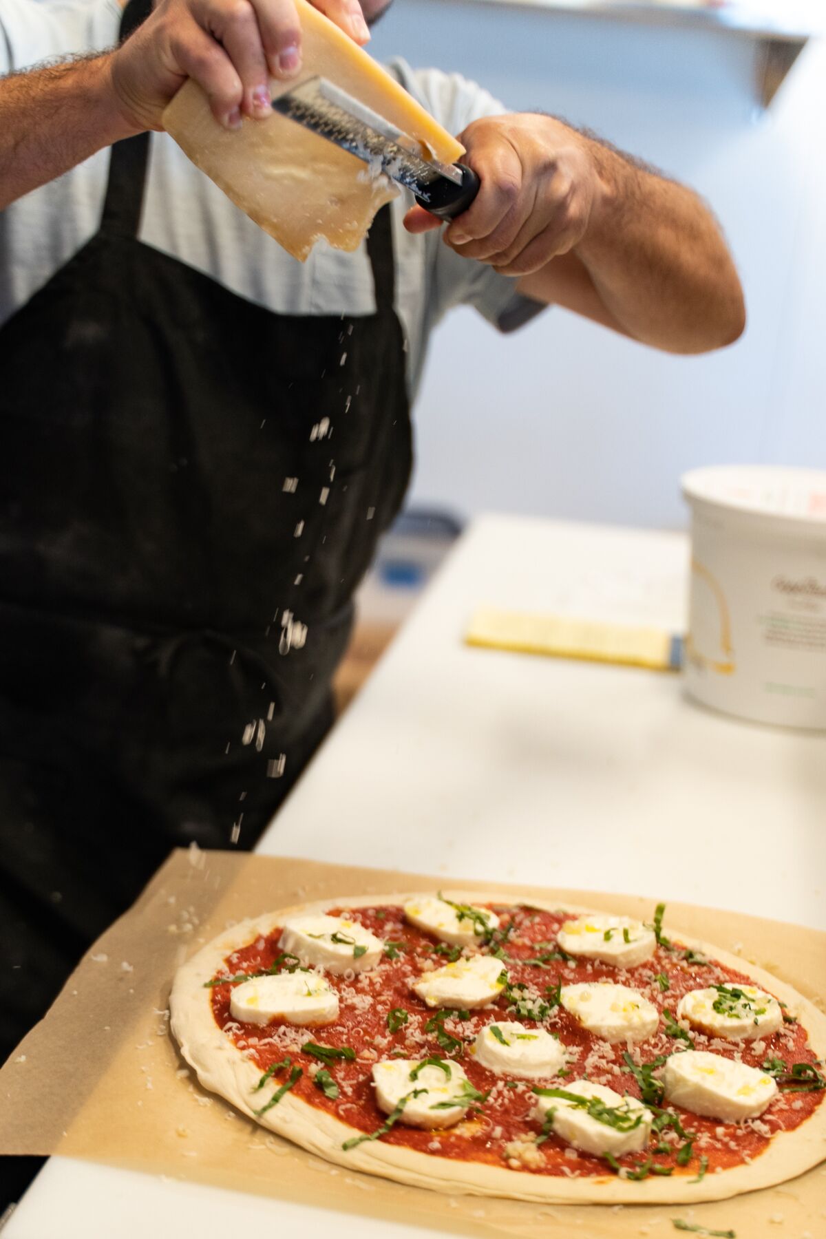 Each American Pizza Mfg. meal is assembled in the shop, then wrapped for customers to cook at home.