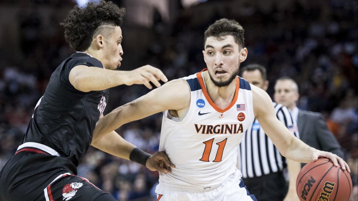 Virginia guard Ty Jerome, right, dribbles the ball against Gardner-Webb guard Jose Perez during Friday's game.