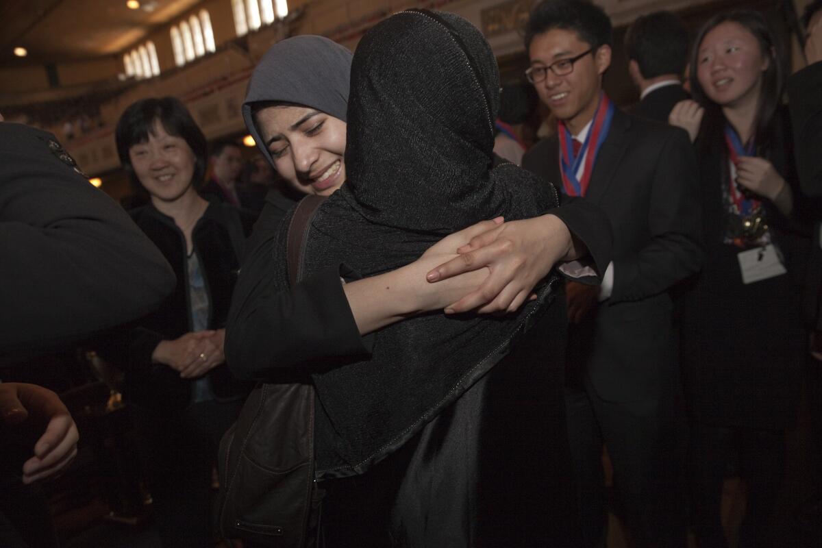 Granada Hills Charter High School senior Hamidah Mahmud of Granada Hills Charter is comforted by her mother, Jahanara, after her team won the state competition last month. The students proceeded to nationals, where they won their third consecutive title.