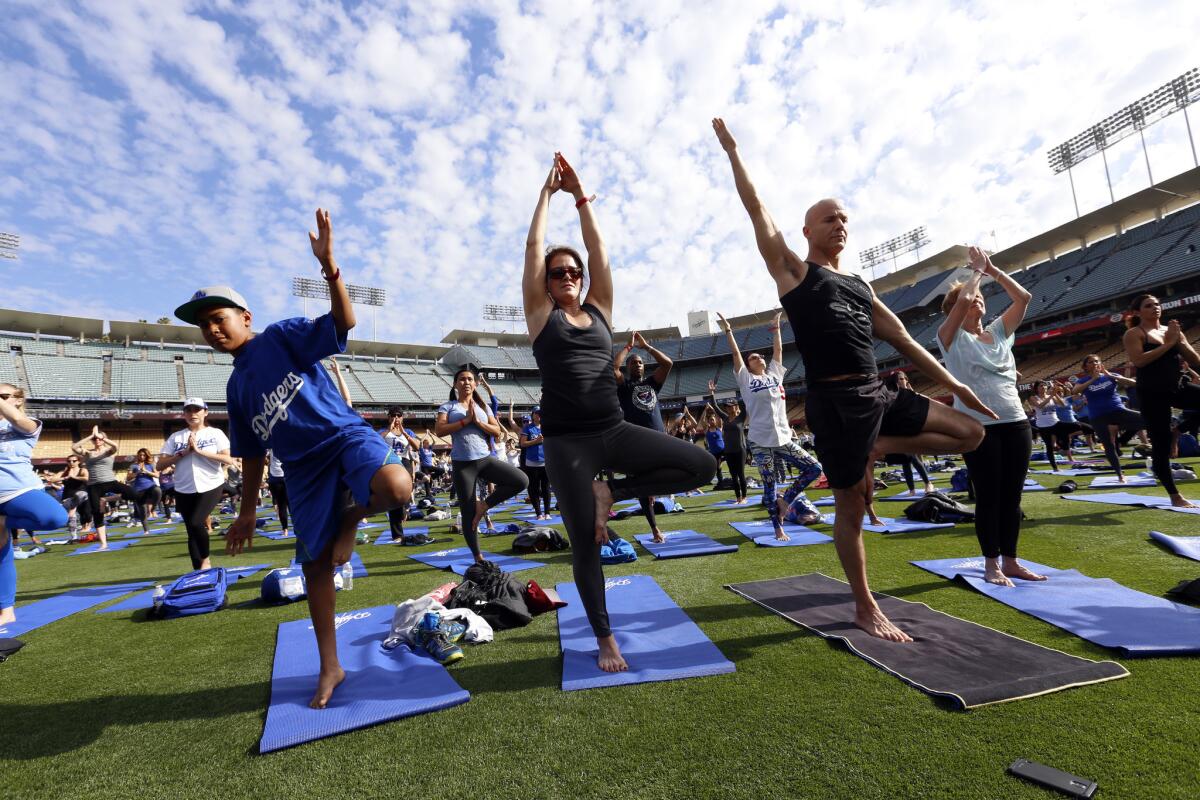 Dodger Stadium attendees bought game tickets that also included a yoga mat and class after the game. The class was led by Mia Togo, who estimated there were 850 participants; the Dodgers said the total was close to 1,000.