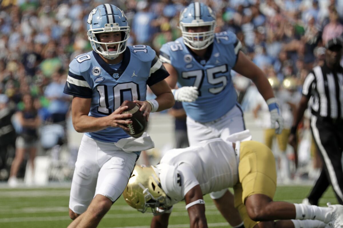 North Carolina quarterback Drake Maye (10) rolls out during the first half of an NCAA college football game against Notre Dame in Chapel Hill, N.C., Saturday, Sept. 24, 2022 (AP Photo/Chris Seward)