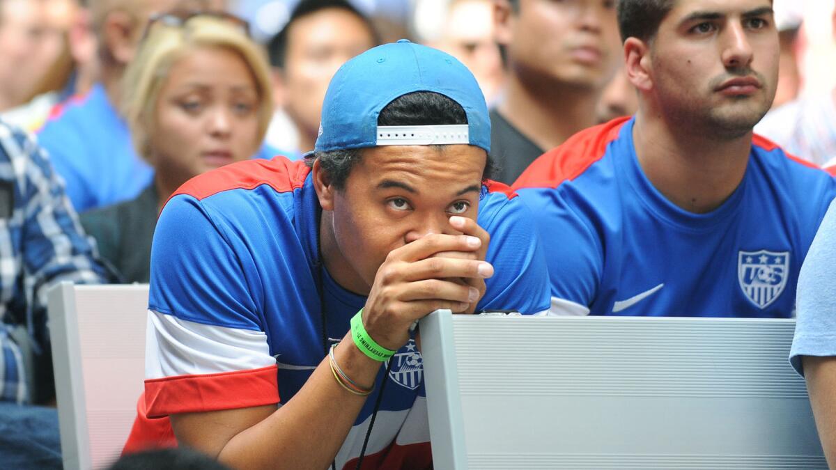 A fan nervously watches the U.S. soccer team against Portugal in the World Cup at a viewing party in downtown Los Angeles.