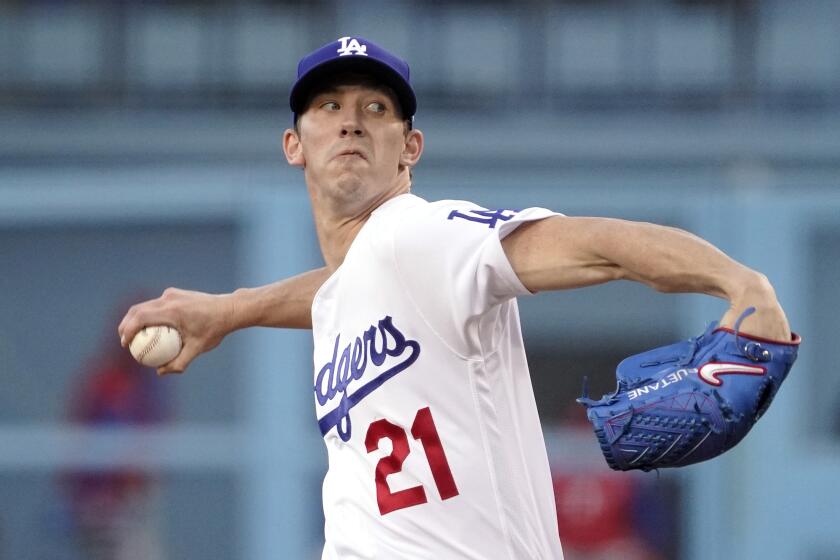 Los Angeles Dodgers starting pitcher Walker Buehler throws to the plate during the first inning.