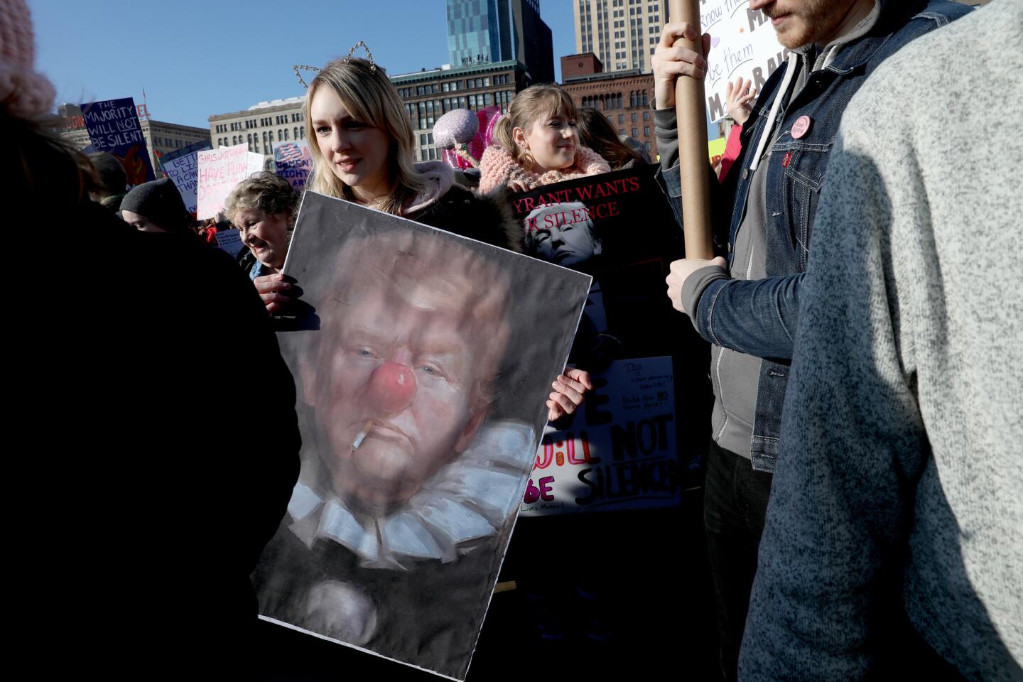 Lucy Lindgren holds a poster while marching with others into Grant Park for the Women's March in Chicago on Jan. 21, 2017.