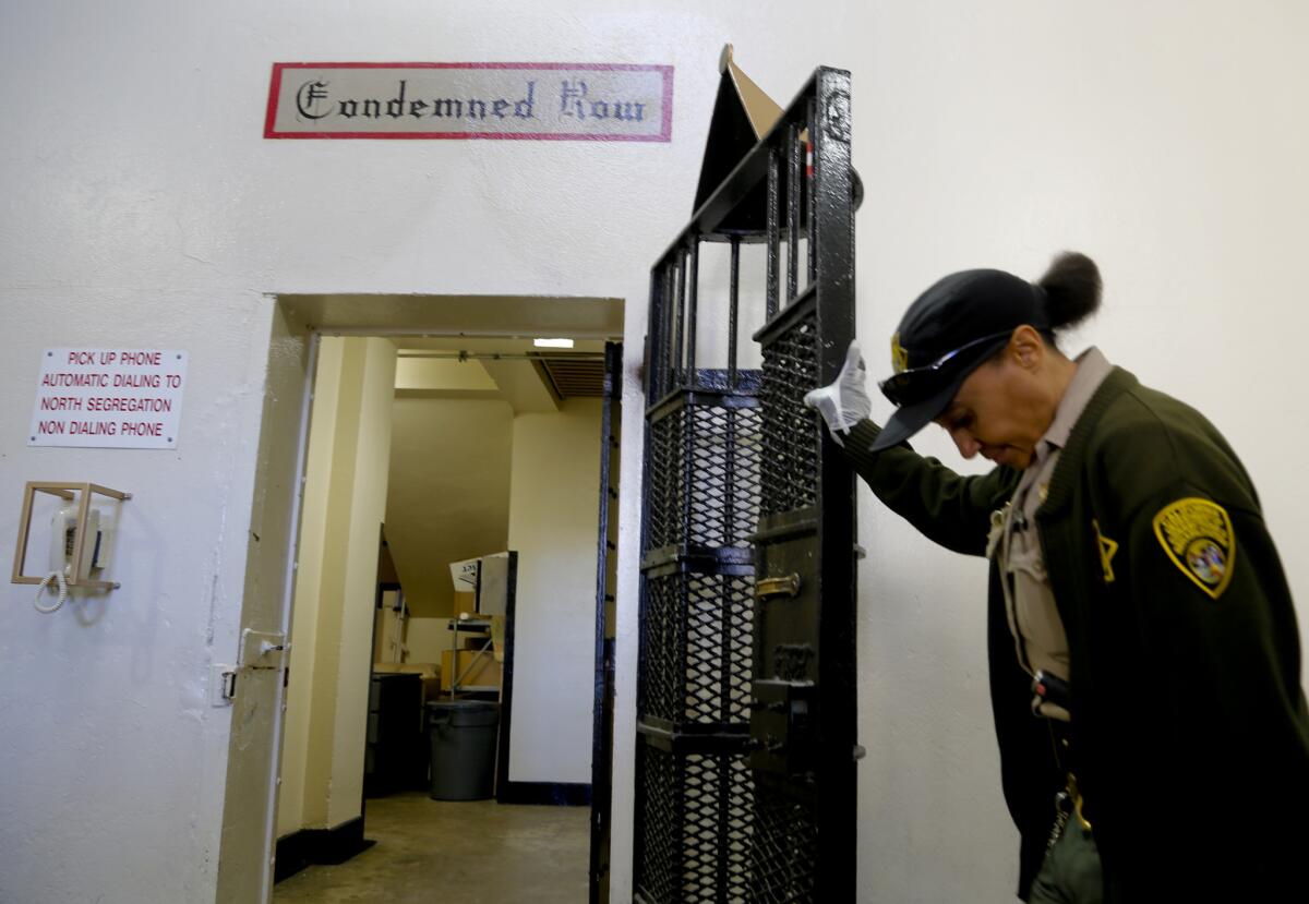 A corrections officer stands guard at the entrance to one of four inmate housing units that hold nearly 700 condemned men at San Quentin State Prison. All are full. The prison is about to open a fifth cellblock for those sentenced to death.