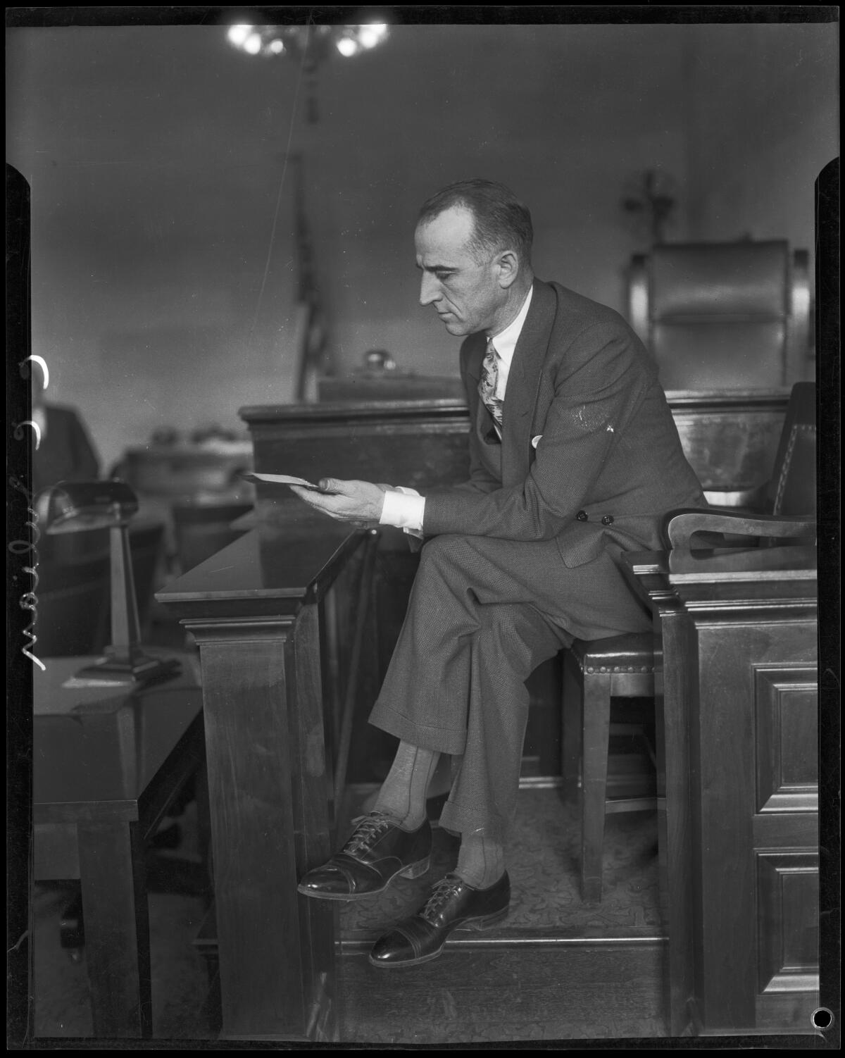 C.C. Julian, L.A. oilman, in a dark suit in a courtroom. Black and white archival image