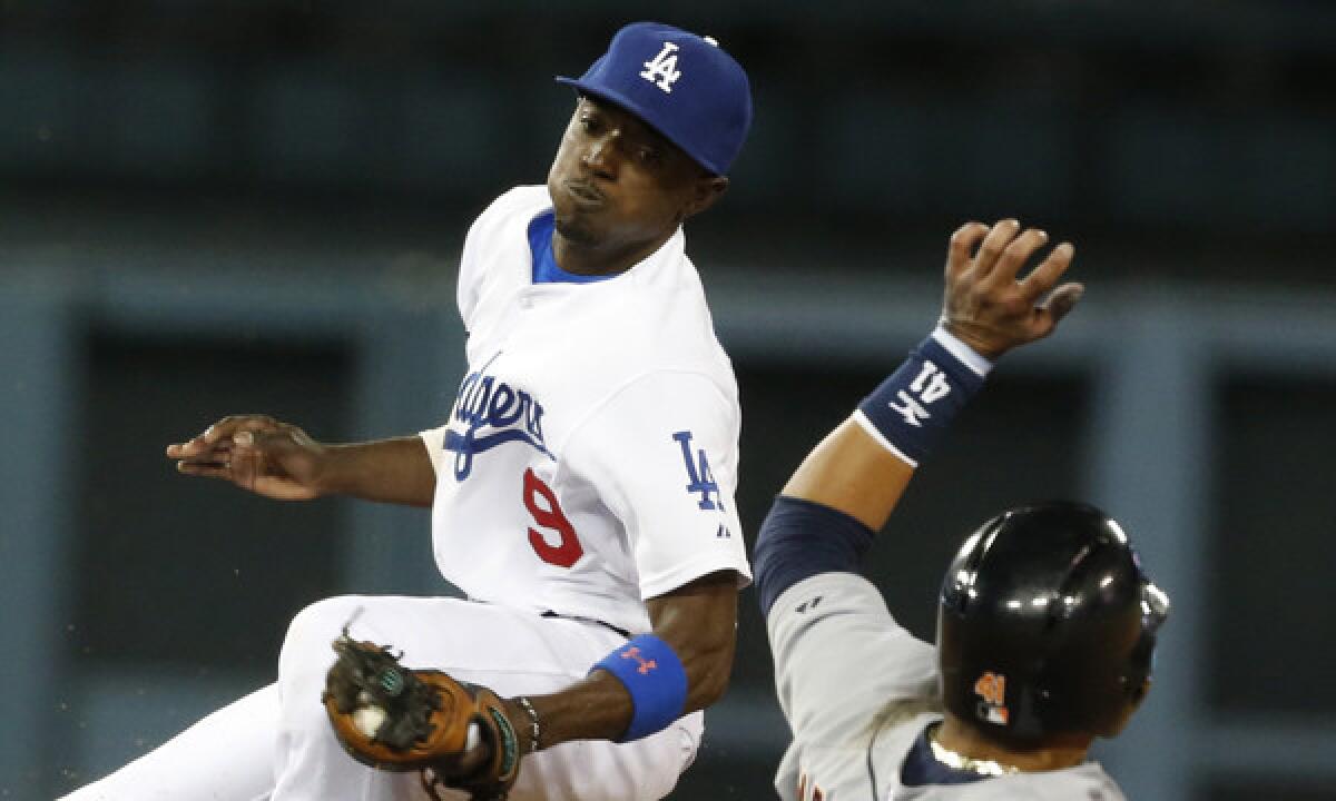 Dodgers shortstop Dee Gordon tags out Detroit Tigers baserunner Victor Martinez on a stolen base attempt during the ninth inning of the Dodgers' eventual 3-2 win in 10 innings Tuesday.
