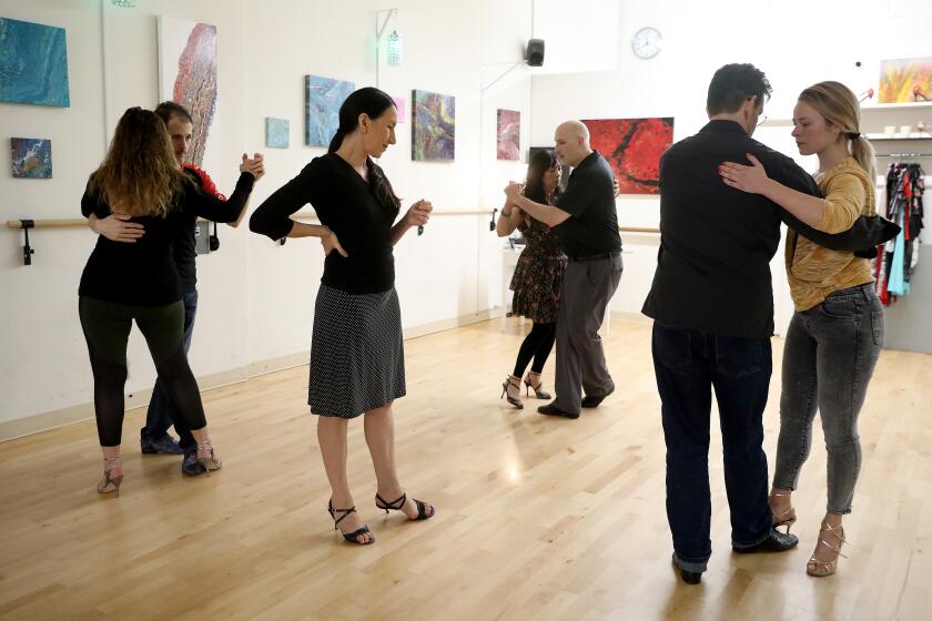 CULVER CITY, CALIF. -- WEDNESDAY, MARCH 11, 2020: Makela Brizuela, founder and director, gives instructions to students during a lesson at Makela Tango Dance Studio in Culver City, Calif., on March 11, 2020. (Gary Coronado / Los Angeles Times)
