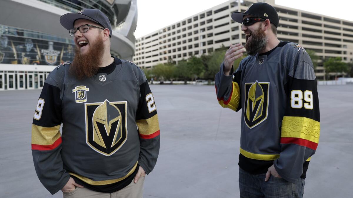 Golden Knights fans Christian Moreton, left, and Jason Bartholomew attend a rally outside T-Mobile Arena on Saturday in Las Vegas.