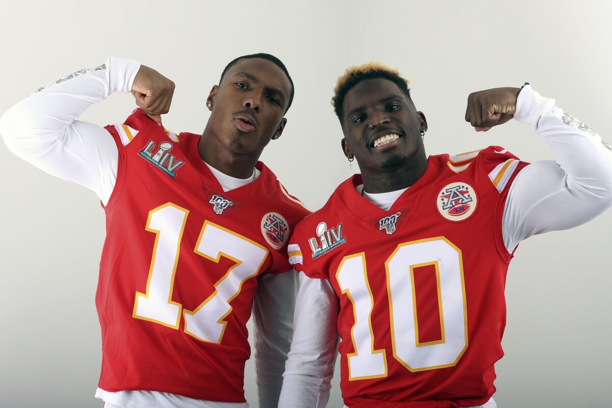FILE - In this Jan. 27, 2020, filer photo, Kansas City Chiefs' Mecole Hardman (17) and Tyreek Hill (10) pose for a photo in Miami. The two Chiefs wide receivers have traded barbs about their speed ever since Hardman was chosen in the second round of last year's draft. Hardman and Hill both have world-class speed — that much was never in question — but just who was the fastest man in Kansas City wasn't settled until the two lined up in the team's indoor facility this past week. Hill won easily. Hardman copped to it on social media with a sad-face emoji. (AP Photo/Doug Benc, File)