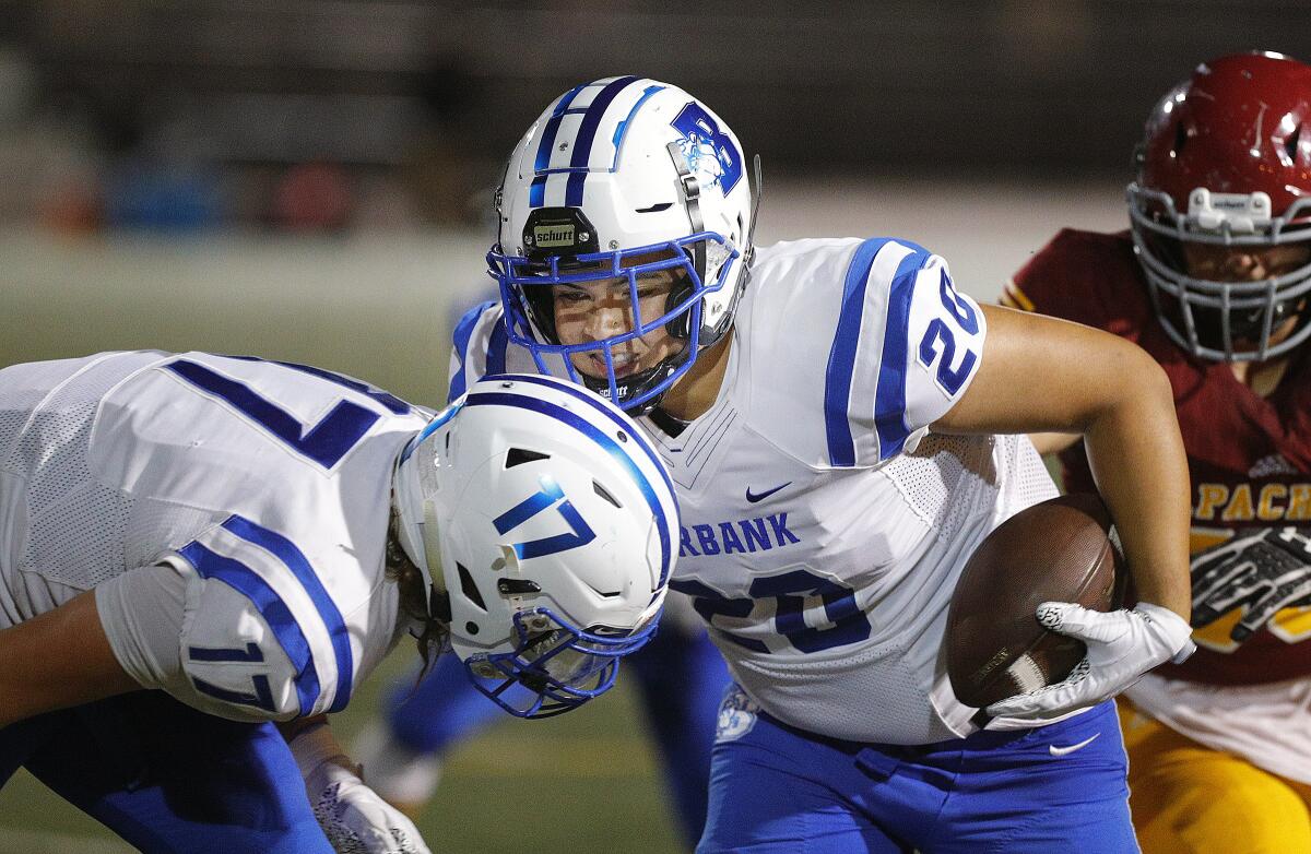 Burbank's Austin Blacano grabs a tipped pass out of the air for an interception and runs against Arcadia in a Pacific League football opener at Arcadia High School on Thursday, September 19, 2019.