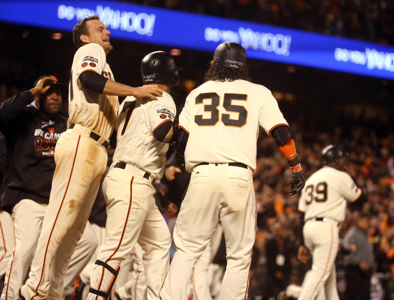 Giants third baseman Conor Gillaspie (left) and teammates celebrate their win in the thirteenth inning over the Cubs on Tuesday, Oct. 11, 2016 in Game 3 of their National League Division Series at AT&T Park in San Francisco.