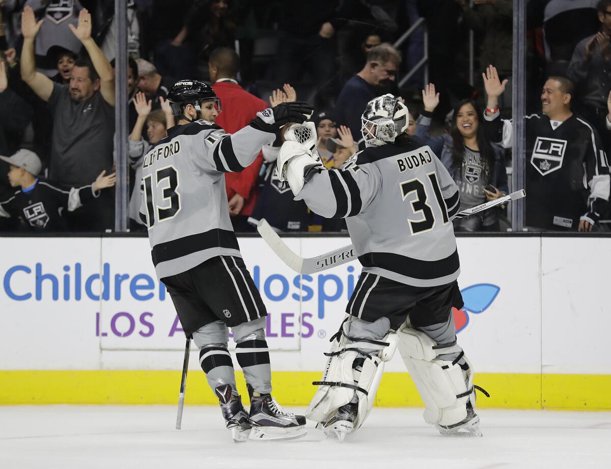 Kings forward Kyle Clifford, left, and goalie Peter Budaj celebrate the team's 4-3 win in a shootout against the Vancouver Canucks on Oct. 22.