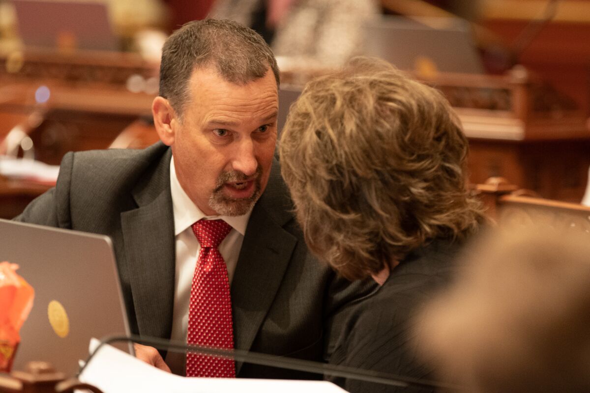 Sen. Brian Dahle speaks to another person during a floor debate