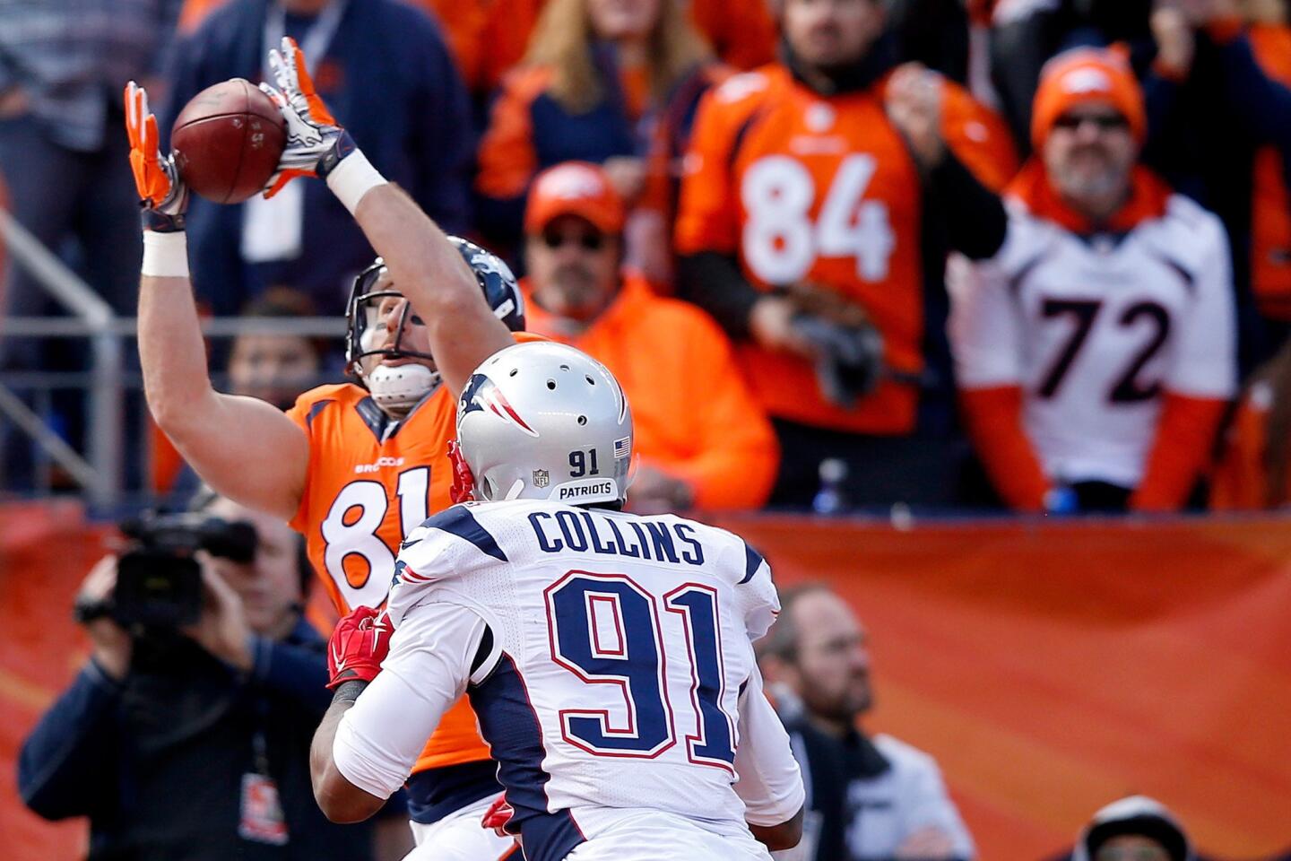 Denver tight end Owen Daniels reaches up for a 12-yard touchdown grab over Patriots linebacker Jamie Collins during the second quarter of the AFC Championship game on Jan. 24.