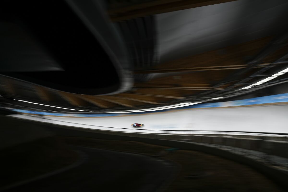 Tobias Wendl and Tobias Arlt, of Germany, slide during the luge doubles run 2 at the 2022 Winter Olympics, Wednesday, Feb. 9, 2022, in the Yanqing district of Beijing. (AP Photo/Pavel Golovkin)