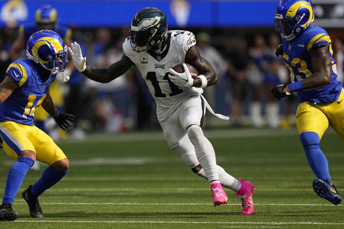 Philadelphia Eagles receiver A.J. Brown runs with the ball between Rams players