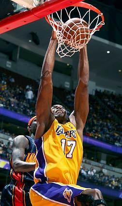 Lakers Andrew Bynum gets a dunk against the Warriors' Stephen Curry. Bynum finished with a team-high 24 points.