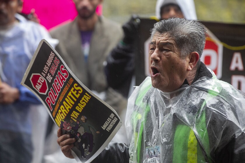 Migrants rights activist Sergio Tamai spoke to the crowd of people who gathered around them at City Hall in Tijuana after he and about 30 immigrants marched from their Zona Norte shelter to protest alleged abuse towards migrants by some municipal police officers on Monday, December 23, 2019.