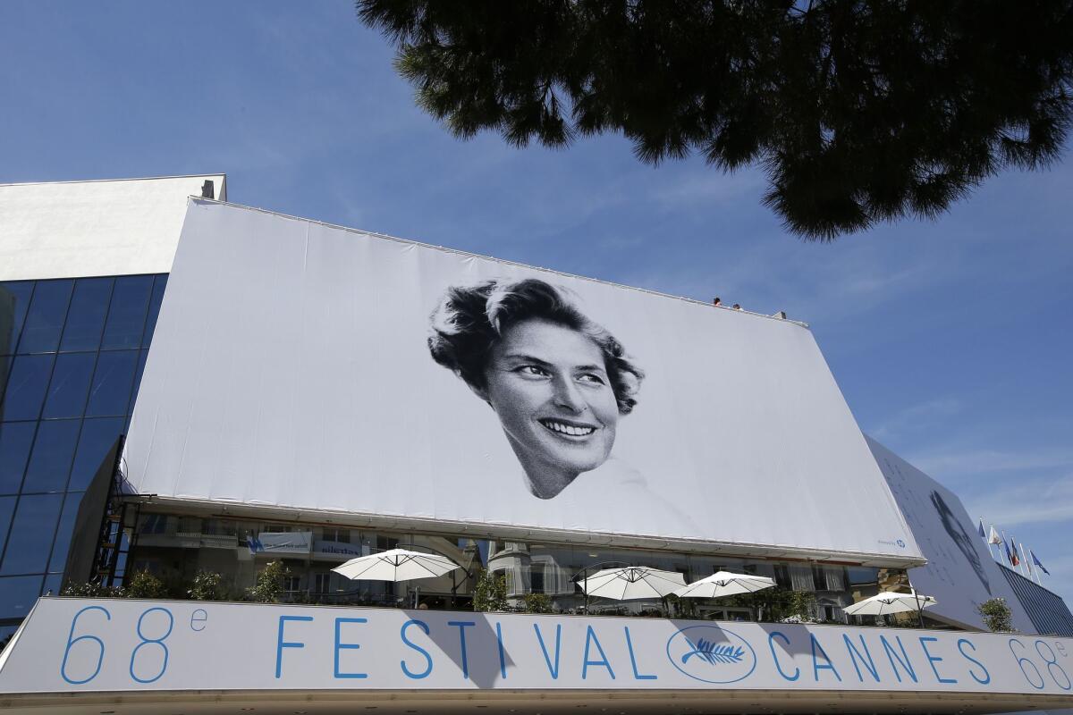 The official poster bearing a portrait of Swedish actress Ingrid Bergman looms over the Festival Palace on the eve of the 68th Cannes Film Festival in Cannes.