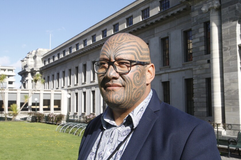 Maori Party co-leader Rawiri Waititi poses for a photo outside New Zealand's Parliament in Wellington in October 2020. Waititi this week won a battle against wearing a tie in the Parliament, ending a longstanding dress requirement that he describes as a "colonial noose." (AP Photo/Nick Perry)