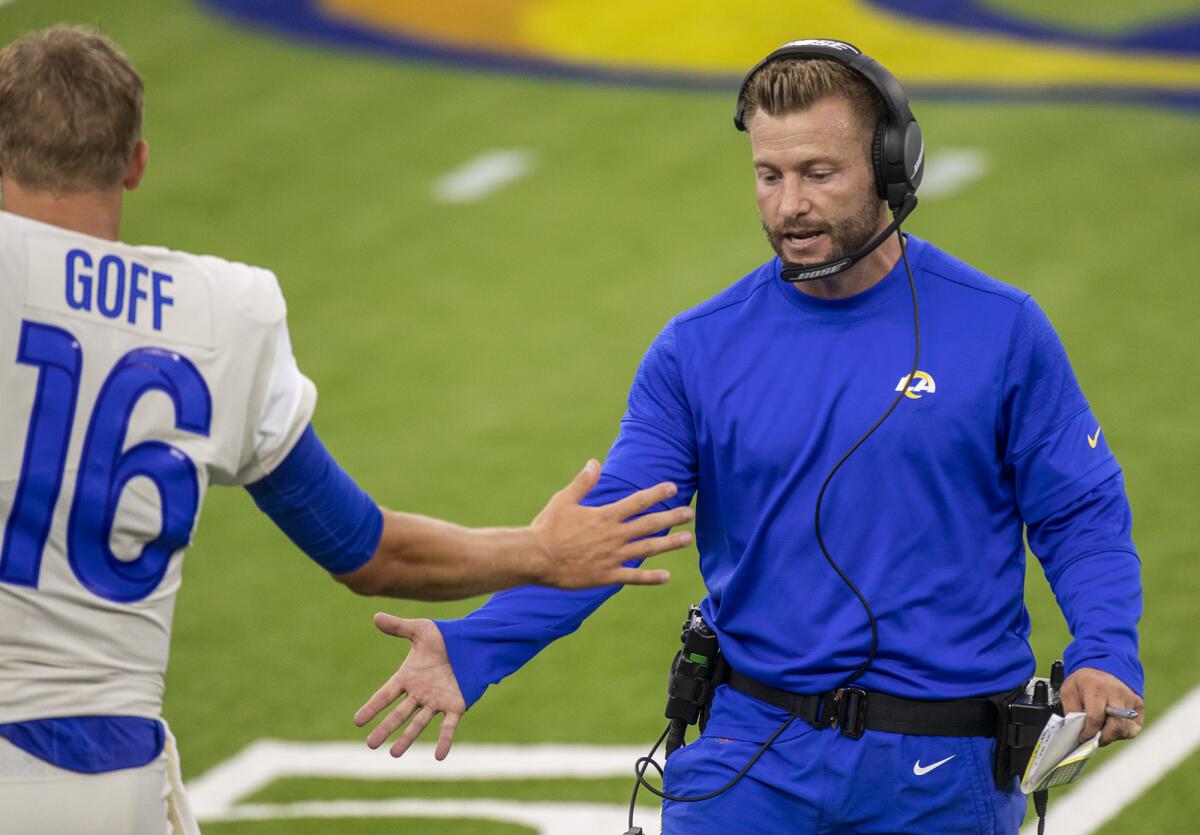Rams head coach Sean McVay low fives quarterback Jared Goff.