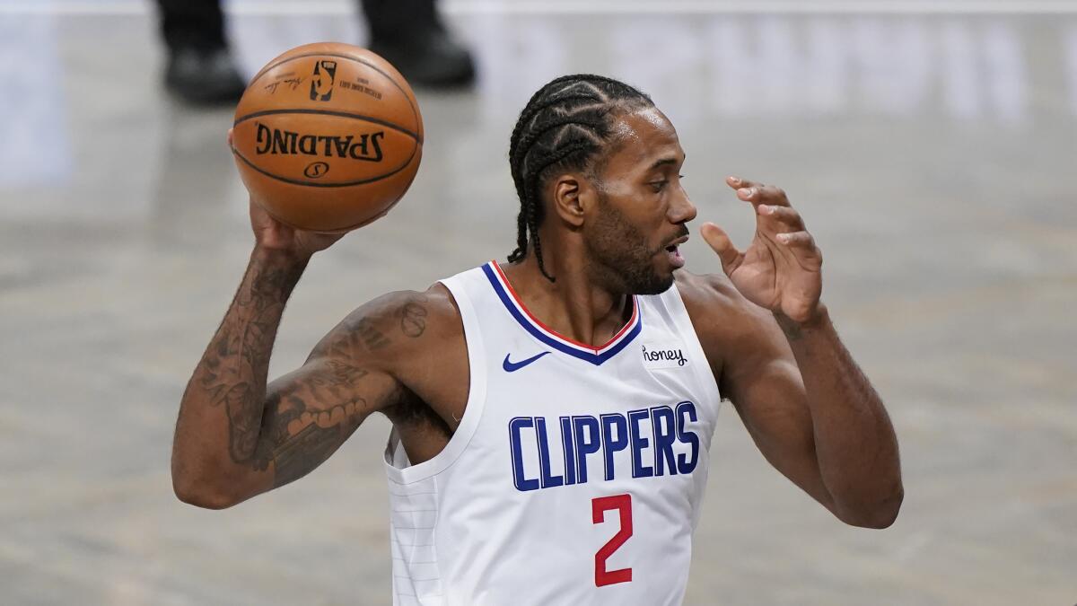 Clippers star Kawhi Leonard controls the ball during a game.