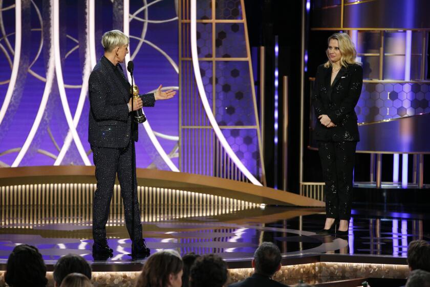 This image released by NBC shows Ellen DeGeneres accepts the Carol Burnett TV Achievement Award as presenter Kate McKinnon, right, looks on at the 77th Annual Golden Globe Awards at the Beverly Hilton Hotel in Beverly Hills, Calif., on Sunday, Jan. 5, 2020. (Paul Drinkwater/NBC via AP)