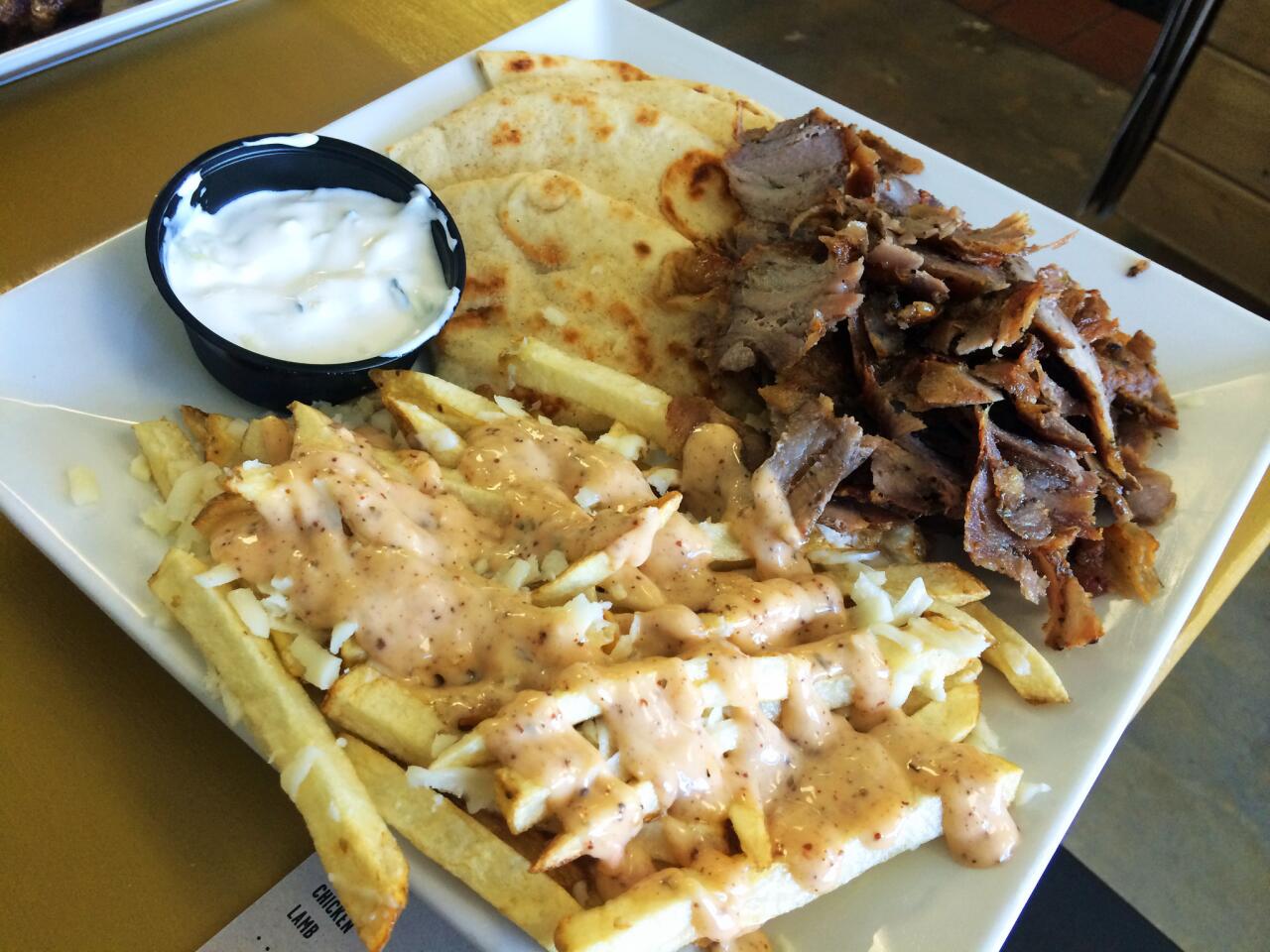 The pork gyro with Langonisi fries covered in a house sauce and Kefalograviera cheese.