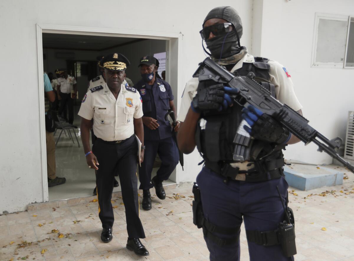Director general of Haiti's police with armed guard