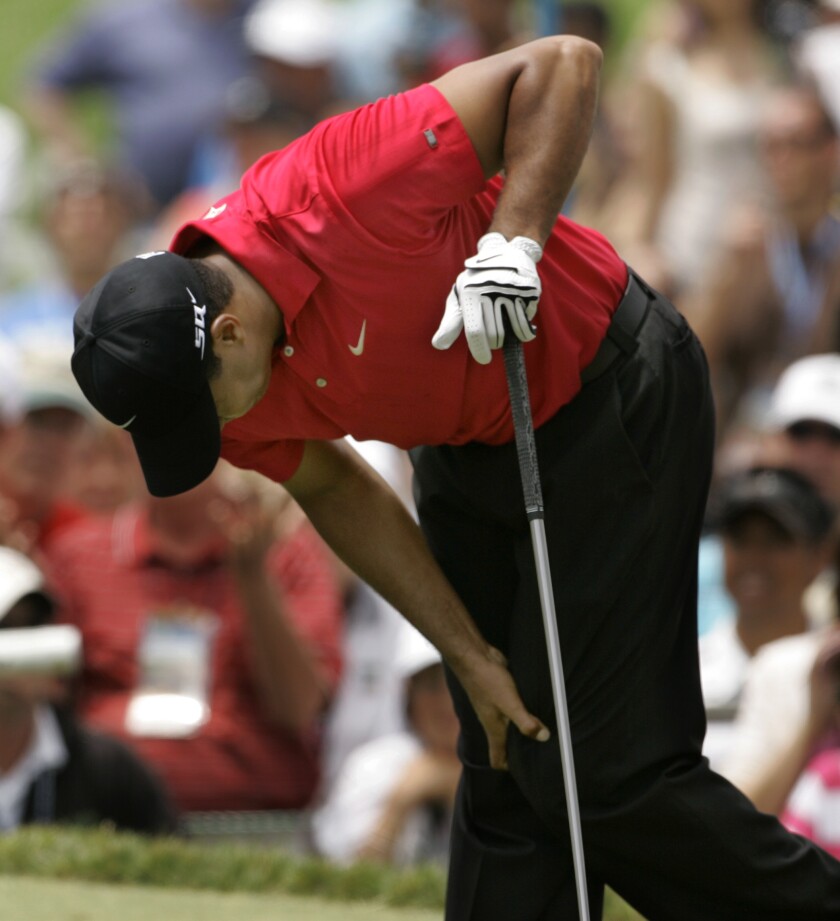 Tiger Woods holds on to his left knee after teeing off on second hole during fourth round of the U.S. Open at Torrey Pines.