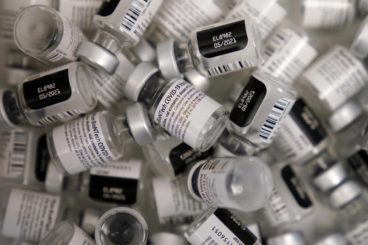 FILE - In this Jan. 22, 2021, file photo, used vials of the Pfizer-BioNTech COVID-19 vaccine lay empty at a vaccination center at the University of Nevada in Las Vegas. The U.S. government announced on Aug. 11, 2021 it will deliver Pfizer vaccines to the Caribbean. (AP Photo/John Locher, File)