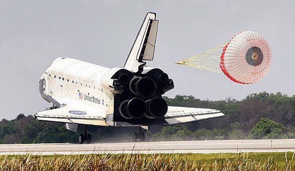 The space shuttle Discovery deploys a drag chute as it touches down at the Kennedy Space Center at Cape Canaveral, Fla. Its 14-day mission to the International Space Station delivered two new sections of Japan's Aerospace Exploration Agency's Kibo laboratory.