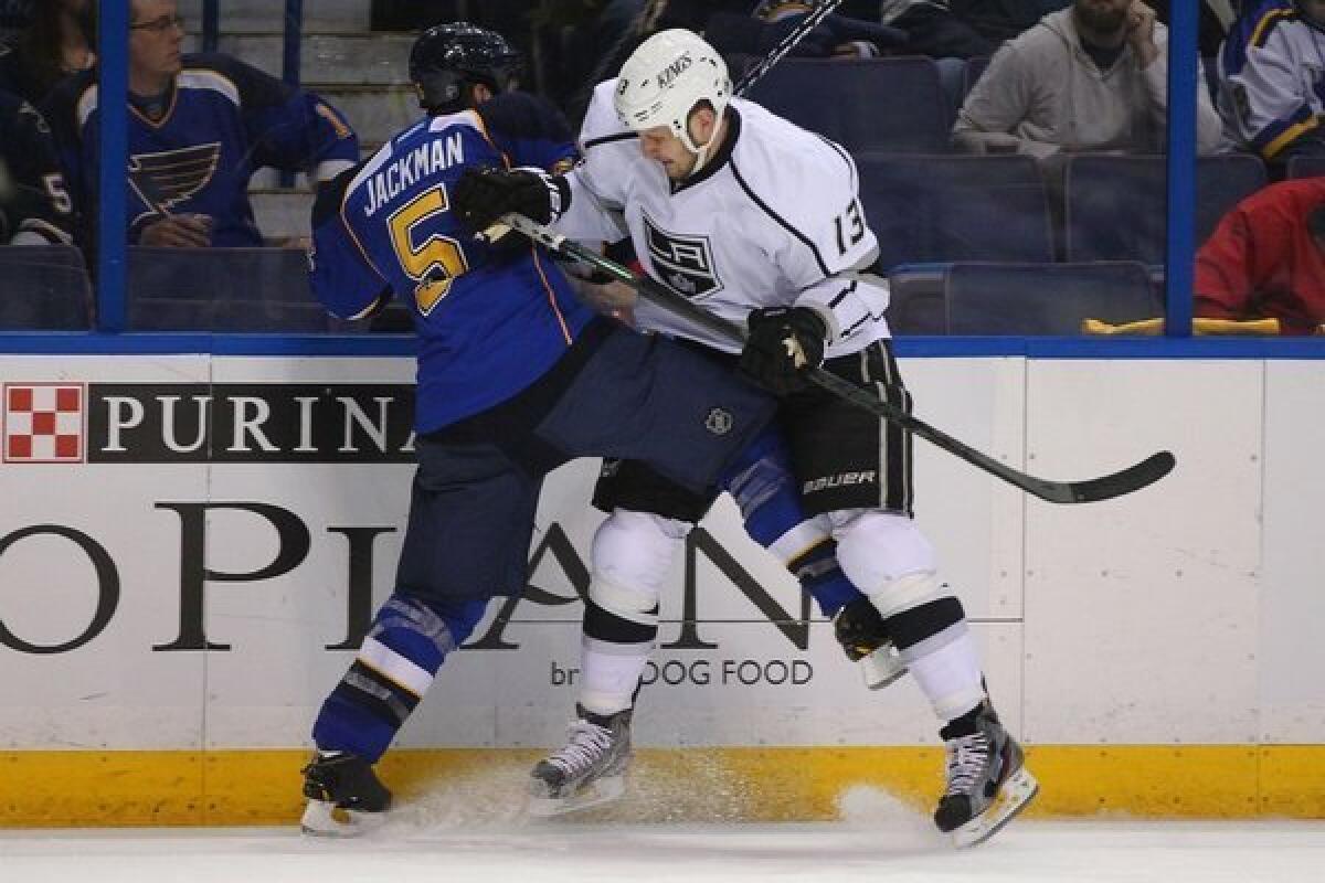 Kyle Clifford of the Kings checks Barret Jackman of the St. Louis Blues into the boards in Game 2.