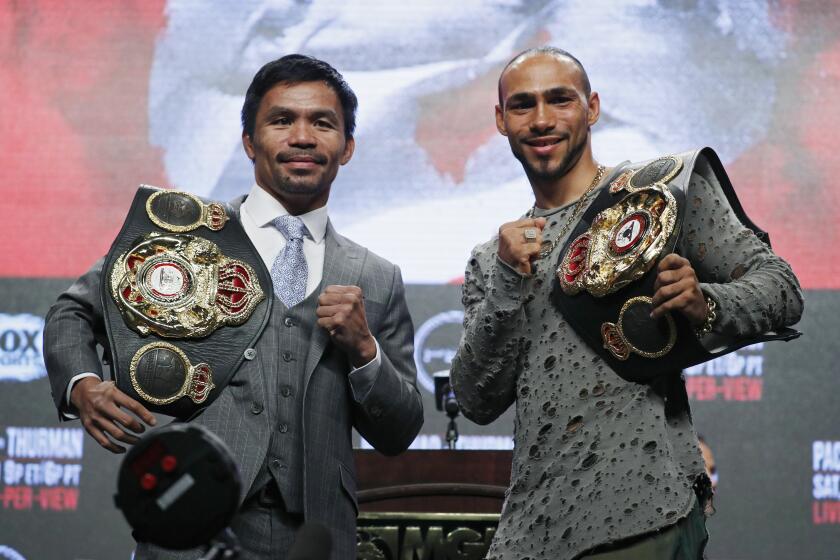 Manny Pacquiao, left, and Keith Thurman pose during a news conference Wednesday, July 17, 2019, in Las Vegas for their welterweight championship boxing match scheduled for Saturday in Las Vegas. (AP Photo/John Locher)