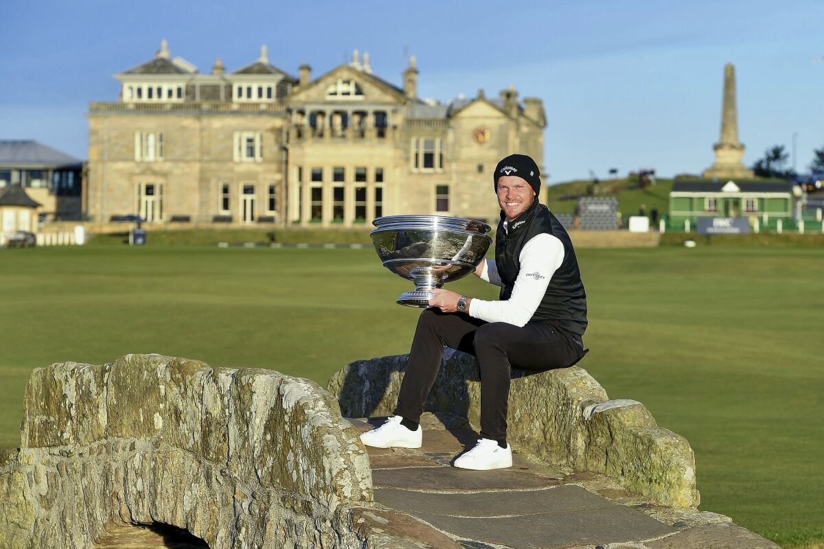 England's Danny Willett poses with the trophy after winning the Alfred Dunhill Links Championship at St Andrews, Scotland, Sunday Oct. 3, 2021. (Malcolm Mackenzie/PA via AP)