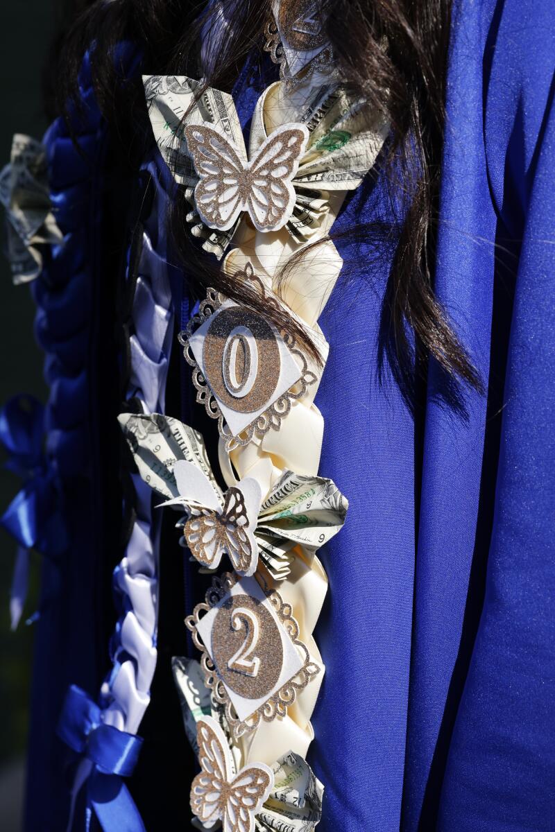 A student wears a decorated tassel.