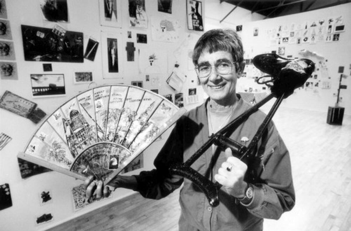 Judith Hoffberg, an authority on mail art, which is loosely defined as anything that can be sent through the mail, holds items from a Pasadena exhibition she curated in 1992.