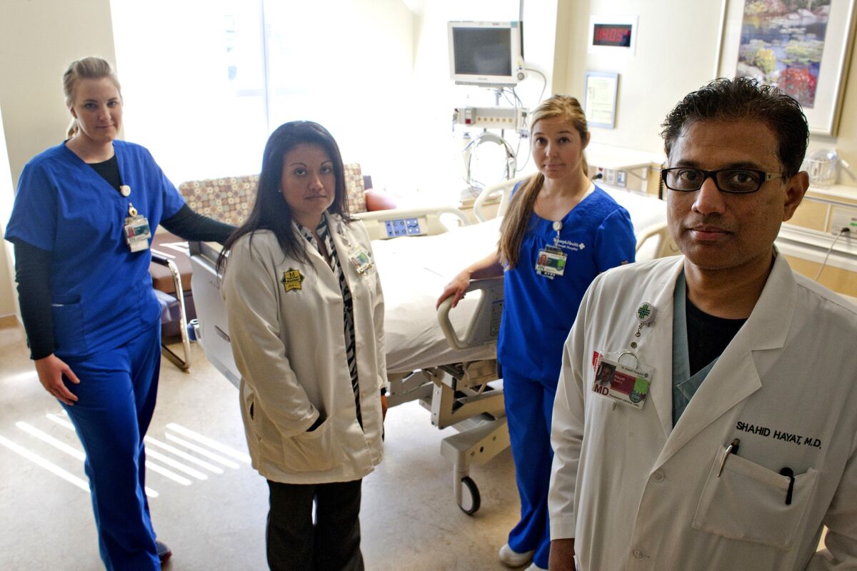 Intensive care nurse Michelle Bruns, left, social worker Melissa Ramirez, nurse Amy Aguilar and Dr. Shahid Hayat took care of beating victim Kim Pham before she was taken off life support in this ICU room at St. Joseph Hospital in Orange.