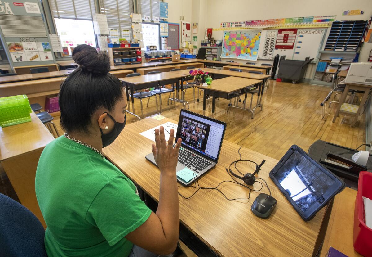 Gladys Alvarez, a fifth-grade teacher, waves goodbye to her students at conclusion of a virtual meet and greet last week.