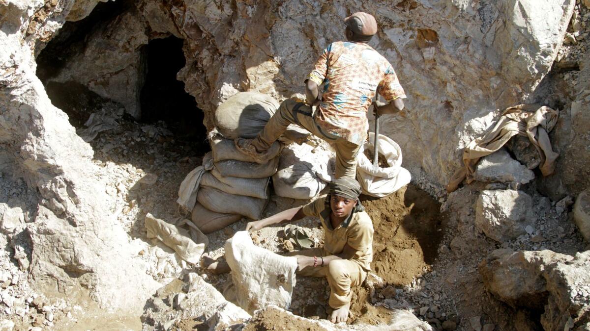 Artisanal miners working by hand in a former industrial copper-cobalt mine near the capital city of Lualaba Province in the Democratic Republic of Congo in June 2016.