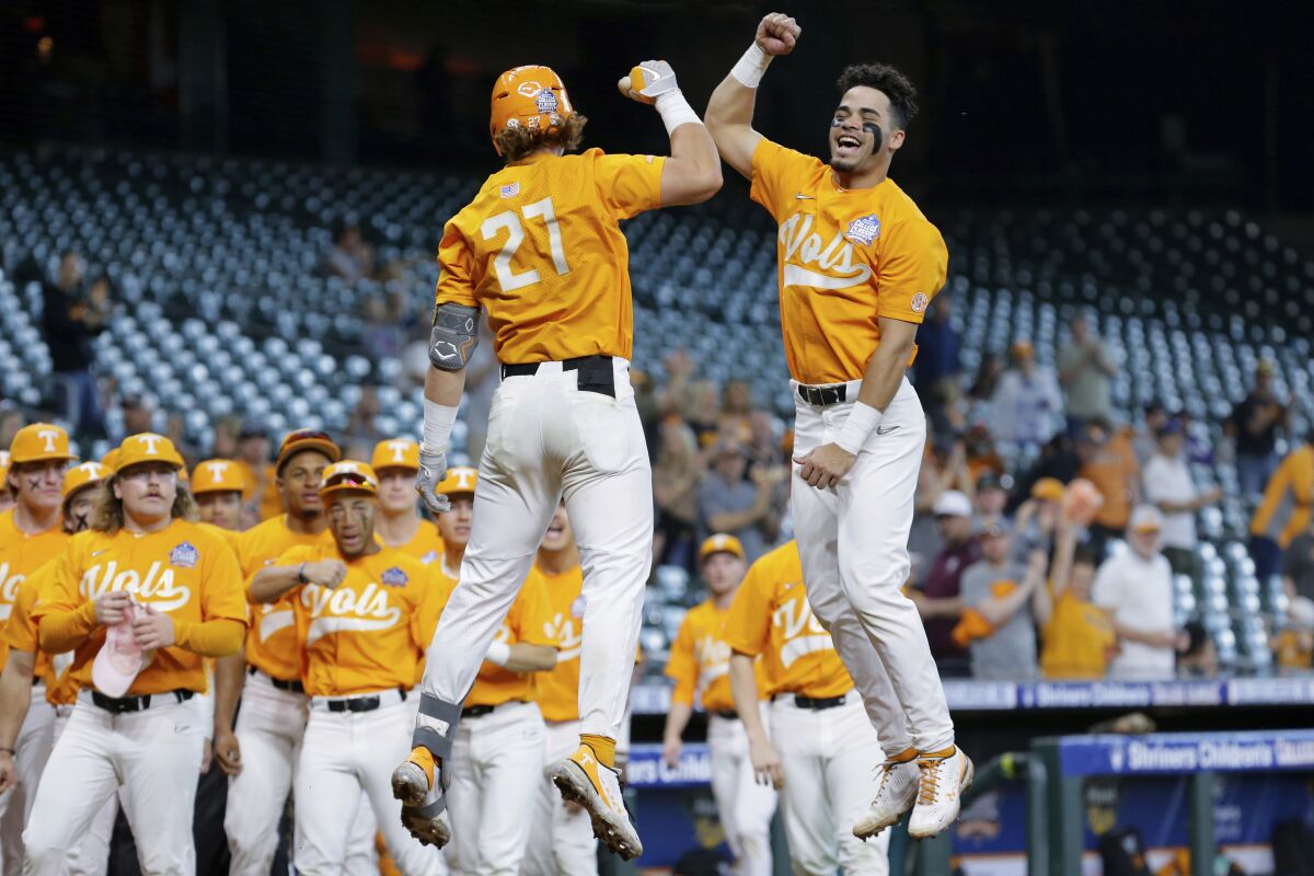 FILE - Tennessee's Jordan Beck (27) and Jorel Ortega, right, jump in celebration of Beck's home run against Oklahoma during an NCAA baseball game on Sunday, March 6, 2022, in Houston. After finishing one of the most dominant runs in Southeastern Conference history, Tennessee was named the No. 1 overall seed in the NCAA baseball tournament Monday, May 30, 2022. (AP Photo/Michael Wyke, File)