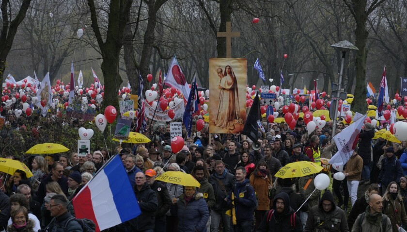 Thousands of demonstrators march in Utrecht, Netherlands, Saturday, Dec. 4, 2021, to protest against COVID-19 restrictions and the lockdown. (AP Photo/Peter Dejong)