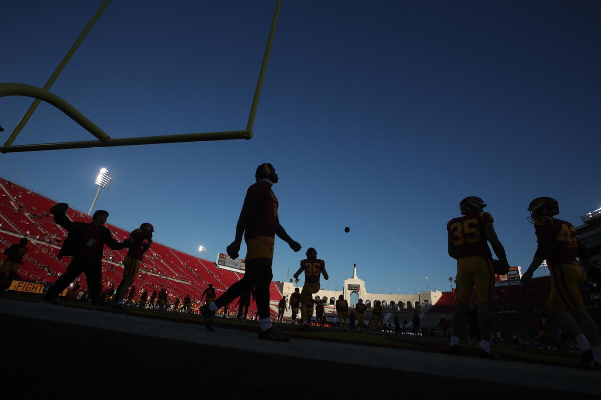 USC players warm up before playing Notre Dame at the Coliseum 