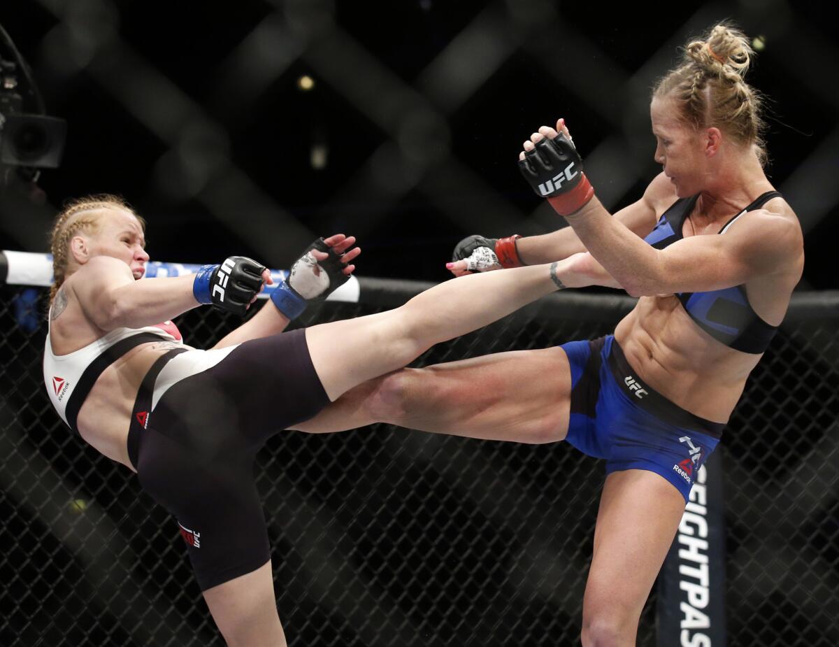Valentina Shevchenko, left, and Holly Holm trade kicks during their bantamweight fight at UFC Chicago on Saturday.