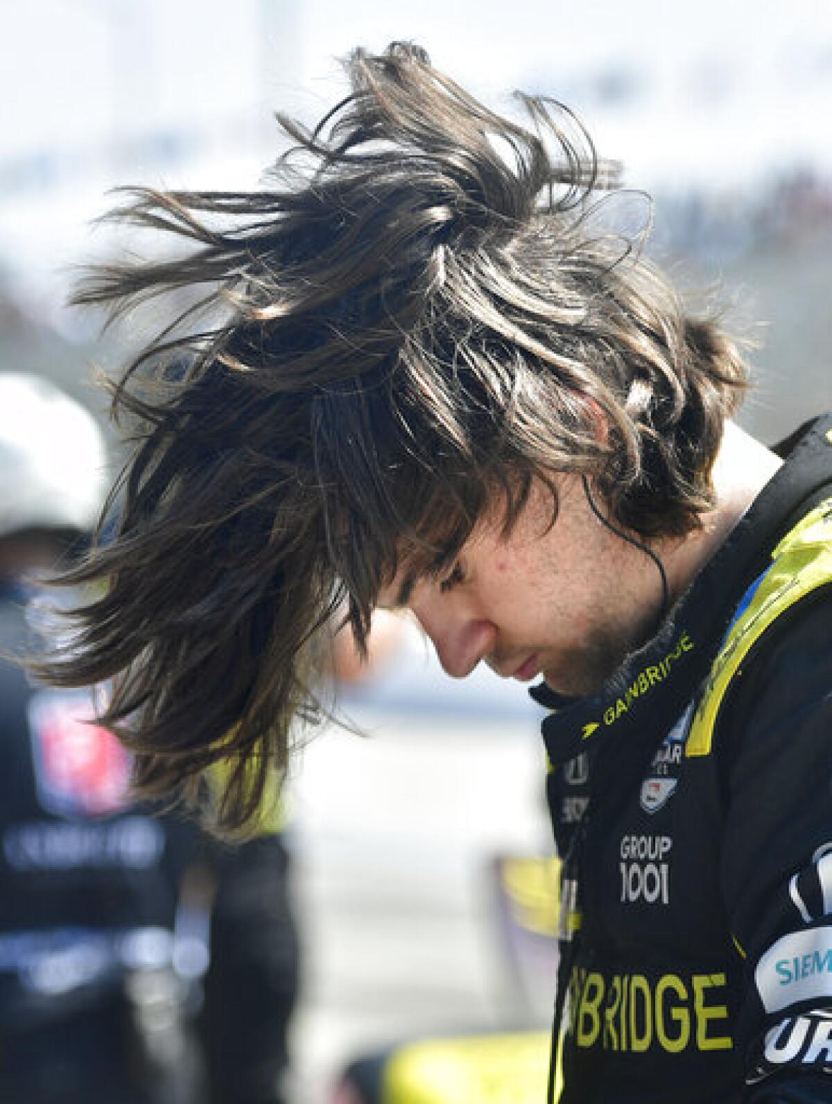 Indycar driver Colton Herta flips his hair after climbing from his race car following qualifying for the Grand Prix of Long Beach auto race Saturday, Sept. 25, 2021, in Long Beach, Calif. (Will Lester/The Orange County Register via AP)