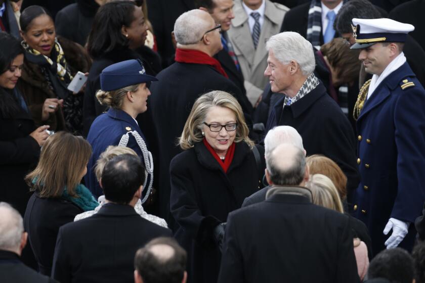 Then-Secretary of State Hillary Clinton and former President Bill Clinton attend the inauguration ceremony for President Obama in 2013.