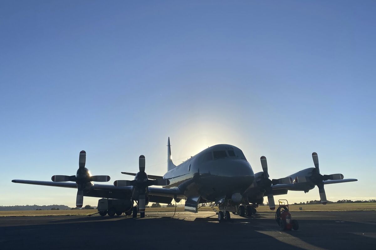 In this photo provided by the New Zealand Defense Force, an Orion aircraft is prepared at a base in Auckland, New Zealand, Monday, Jan. 17, 2022, before flying to assist the Tonga government after the eruption of an undersea volcano. (NZDF via AP)