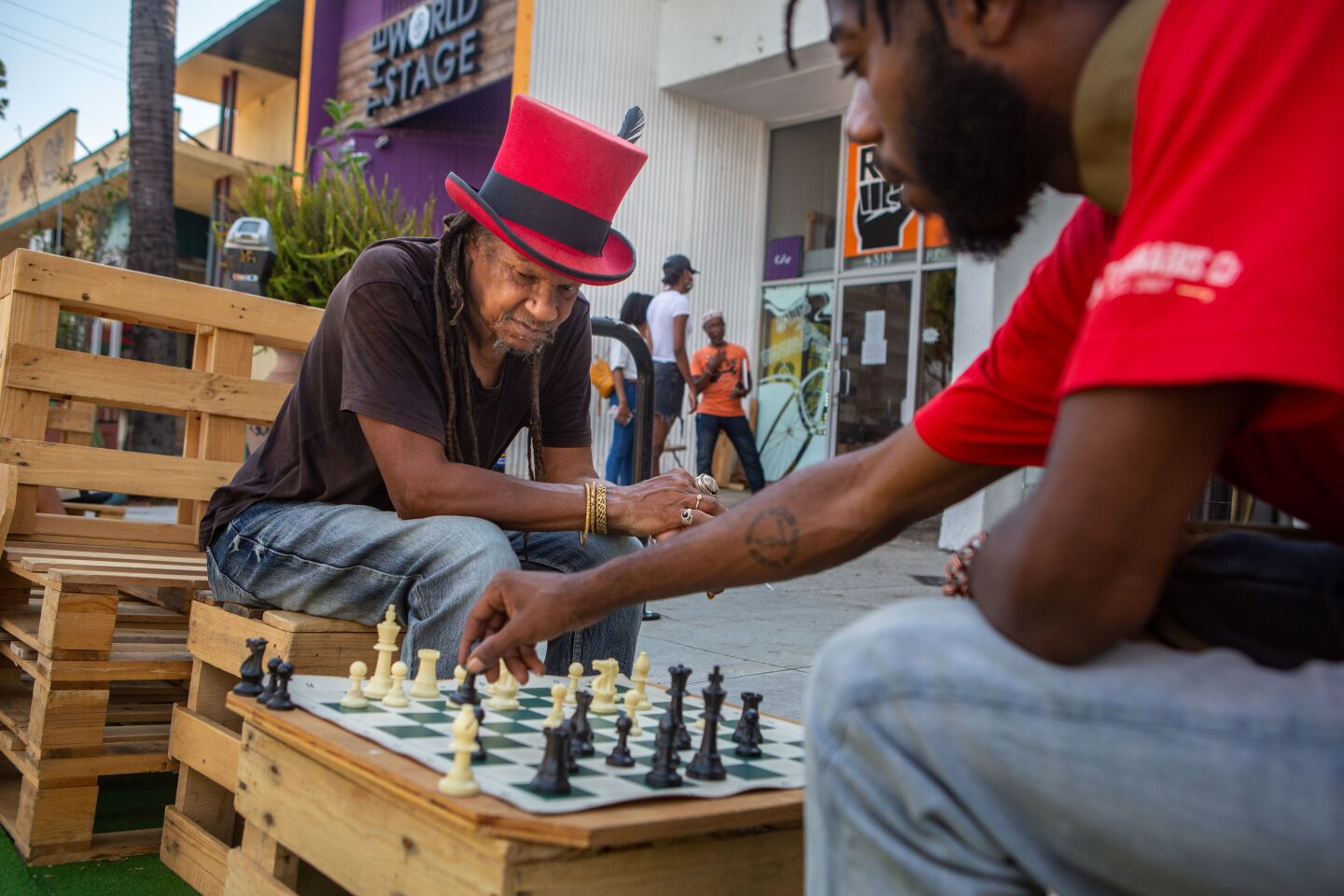 The Original Snake Doctor, left, and Louis Benton play a game of chess in Leimert Park.