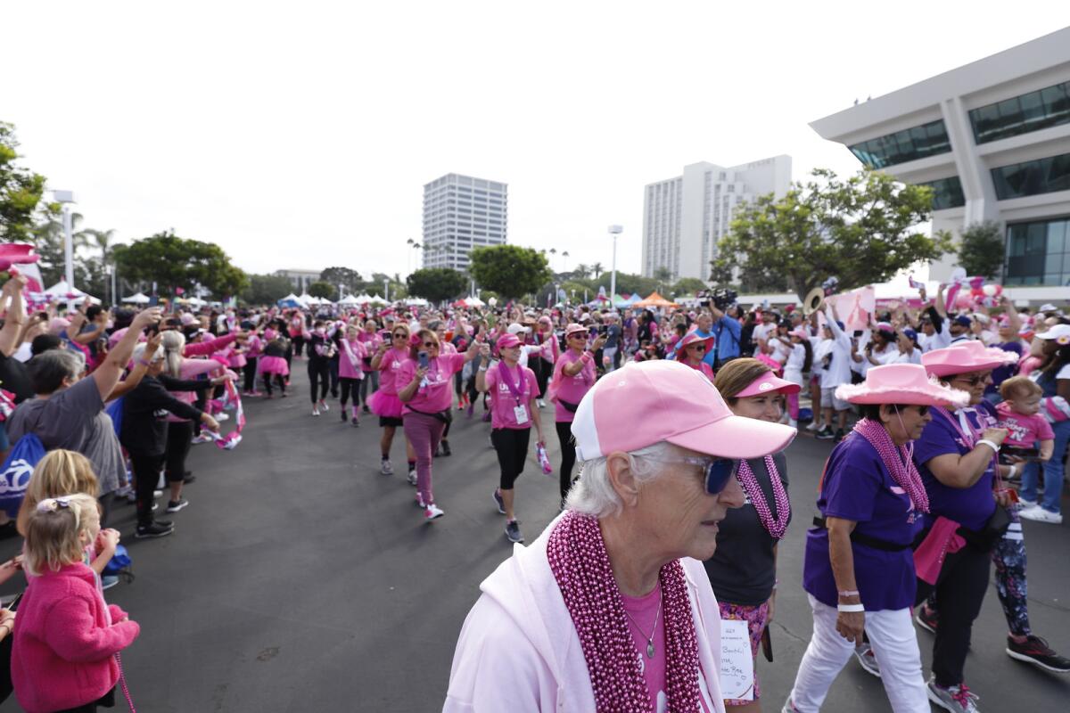 Wearing pink, breast cancer survivors and supporters at Fashion Island.